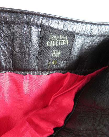 Close-up of a Jean Paul Gaultier label on a garment with red lining.