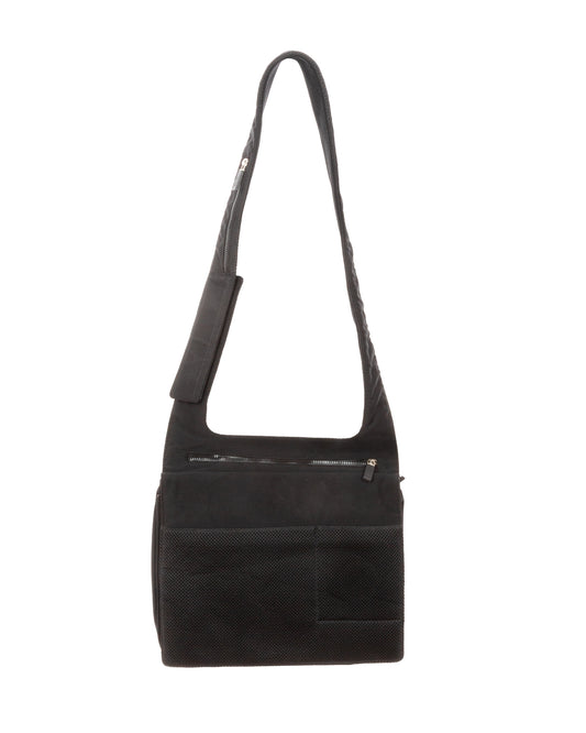 A black technical shoulder bag with a wide sculptural strap and square body, featuring a front zip pocket and subtle embossed Miu Miu branding above the zipper.