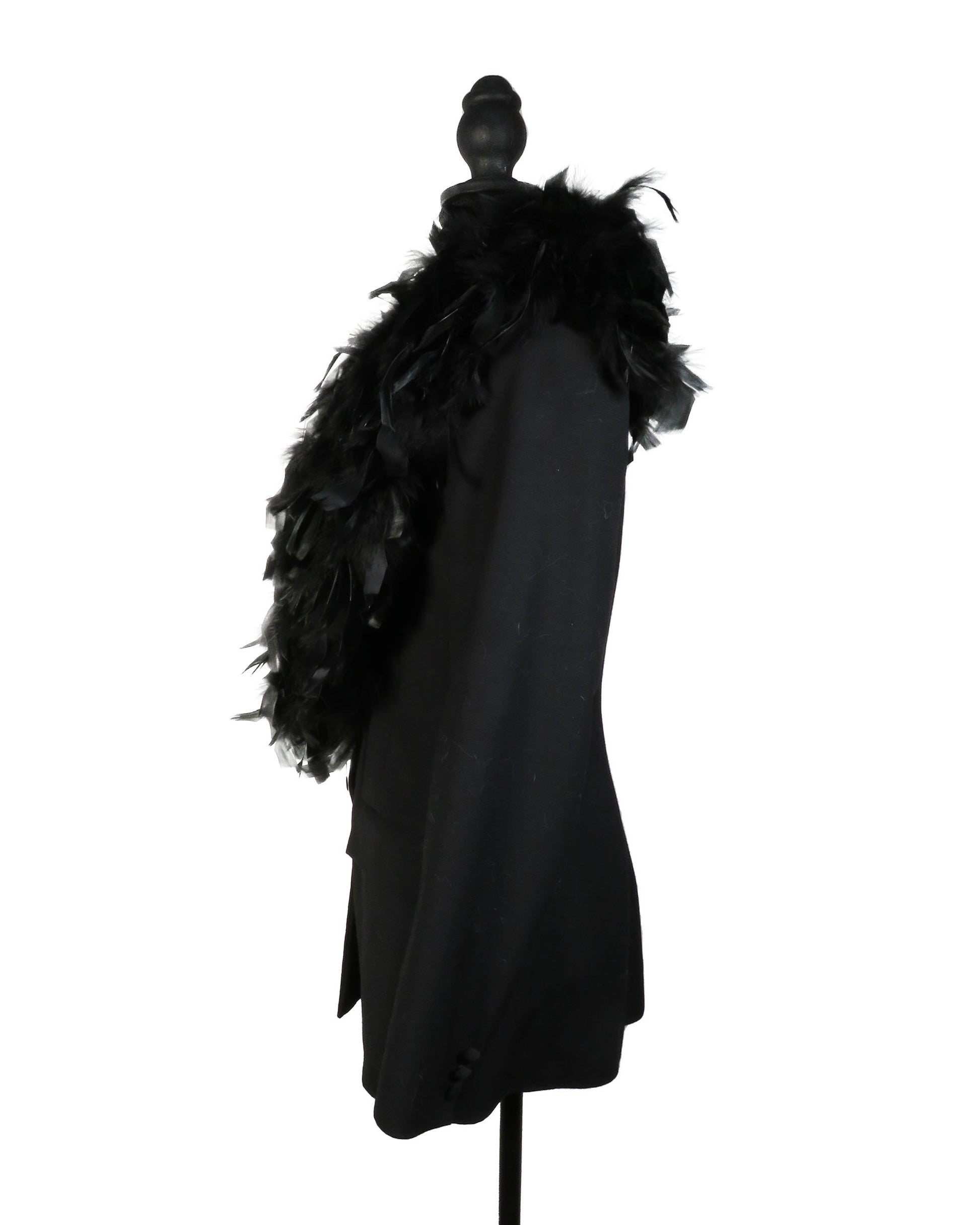 Black coat with feathered hood on a mannequin against a white background