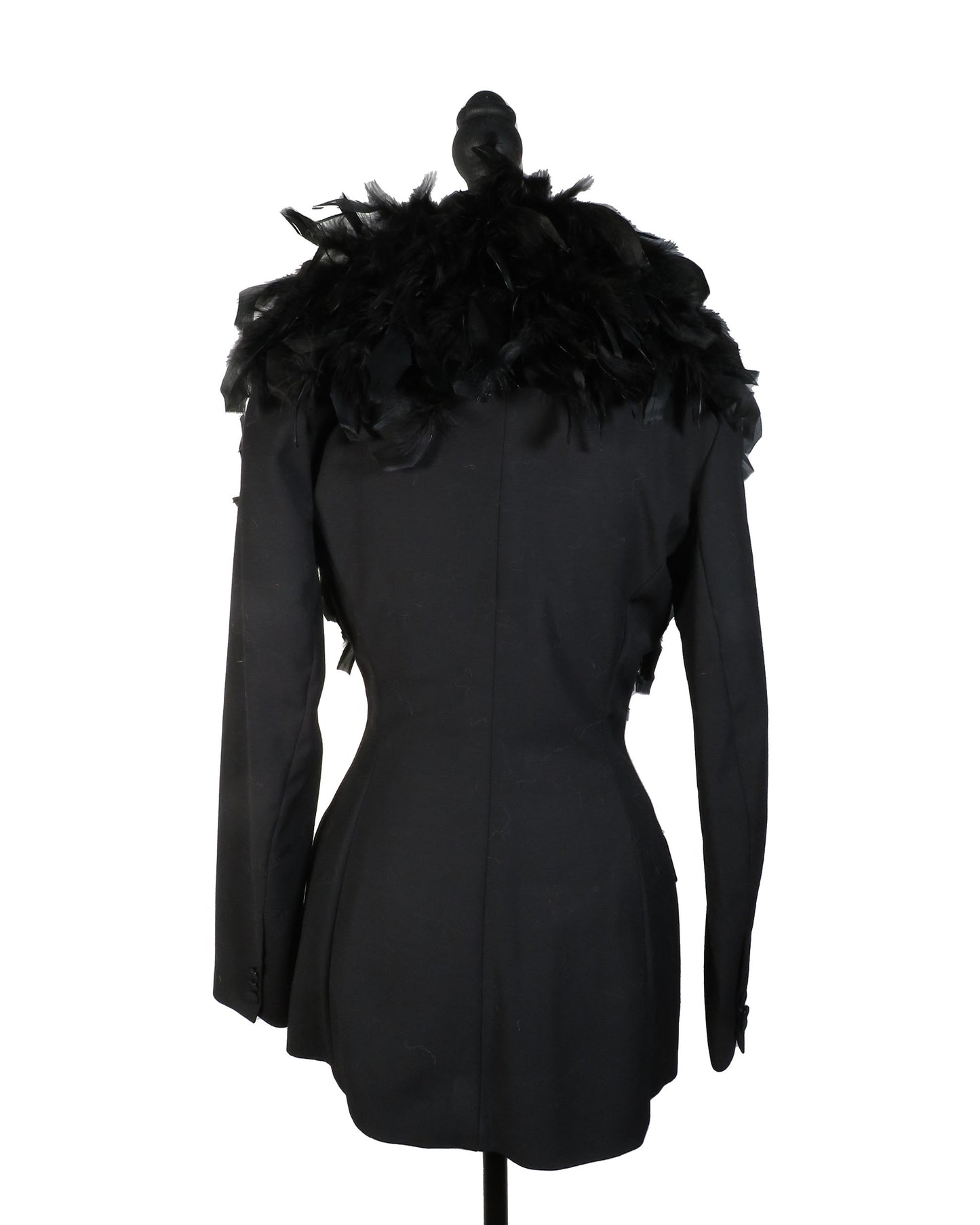 Black coat with feathered shoulders on a mannequin against a white background