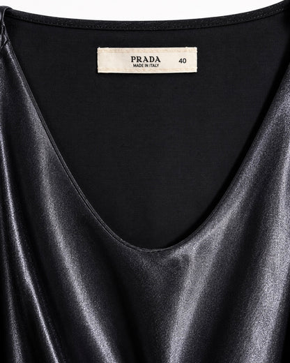 Black satin garment with Prada label on a white background
