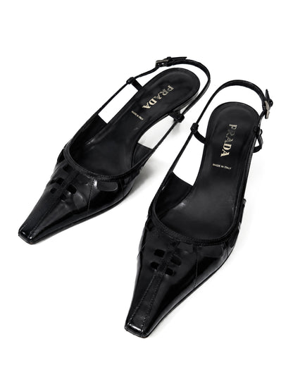 Black high-heeled shoes with Prada logo on a white background