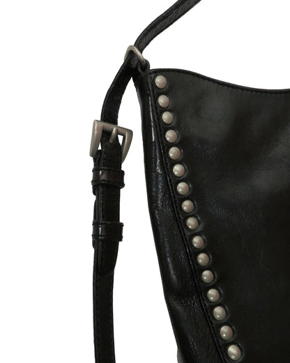 Black leather bag with studded details on a white background