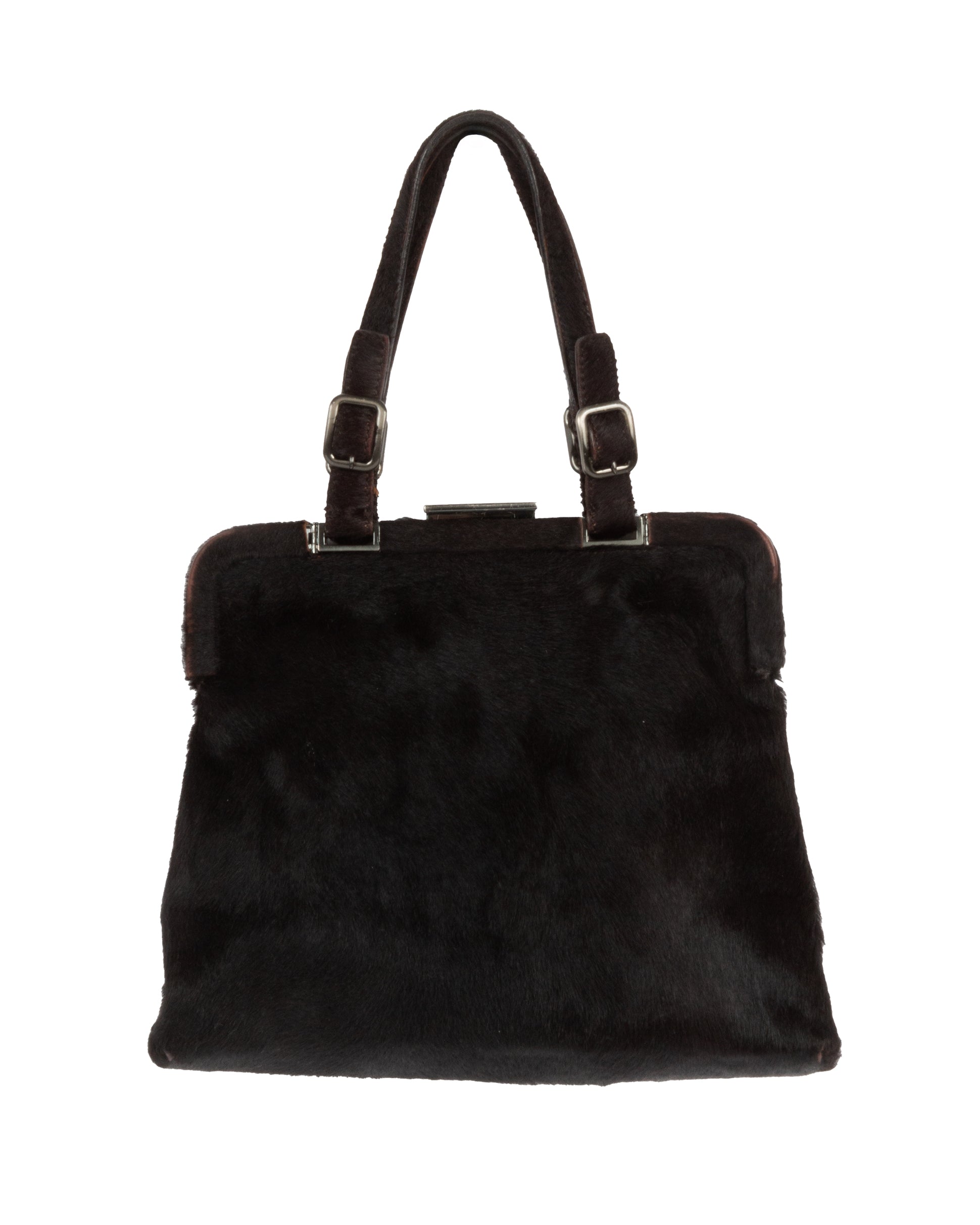 A dark brown fur frame bag with silver-tone hardware and dual adjustable handles. The bag is closed and displayed against a plain background.