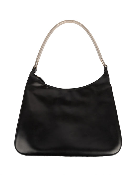 A black leather shoulder bag with a silver-tone metal handle, from Prada's Fall/Winter 1998 collection.