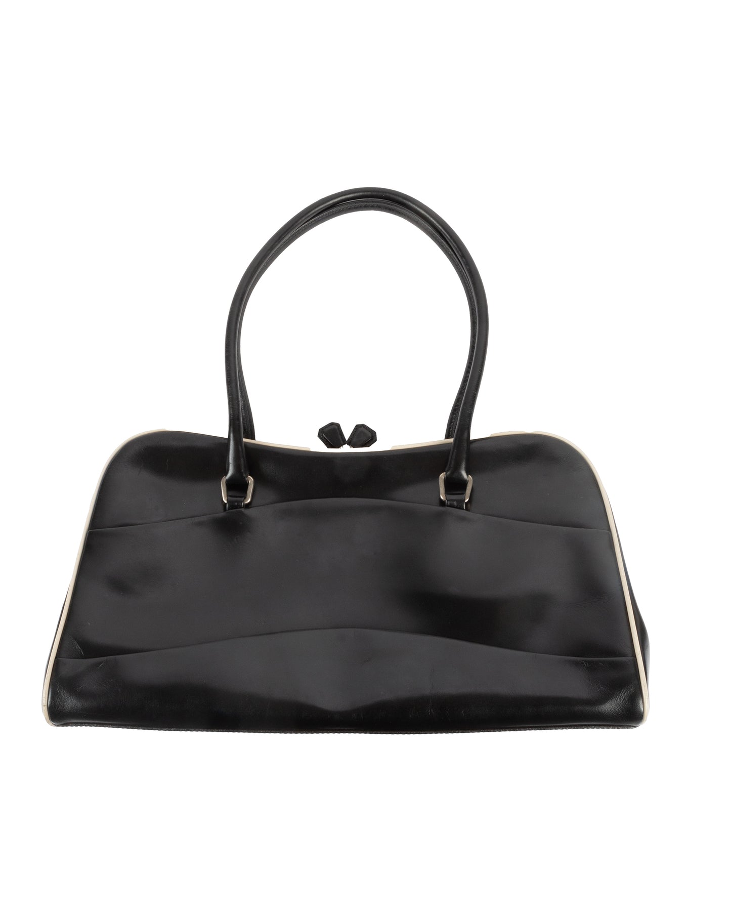 A black leather handbag with a kiss lock closure and double handles, featuring white piping along the edges and Prada's signature logo on the side.
