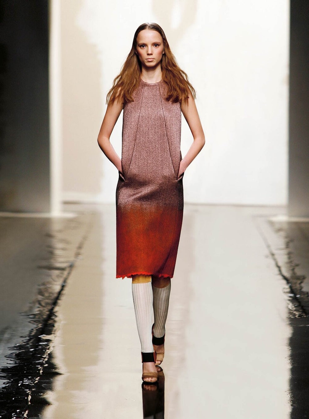 Model walking on a runway wearing a gradient dress.