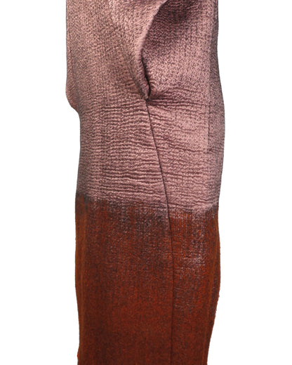 Textured fabric swatch with gradient color from pink to brown on a white background