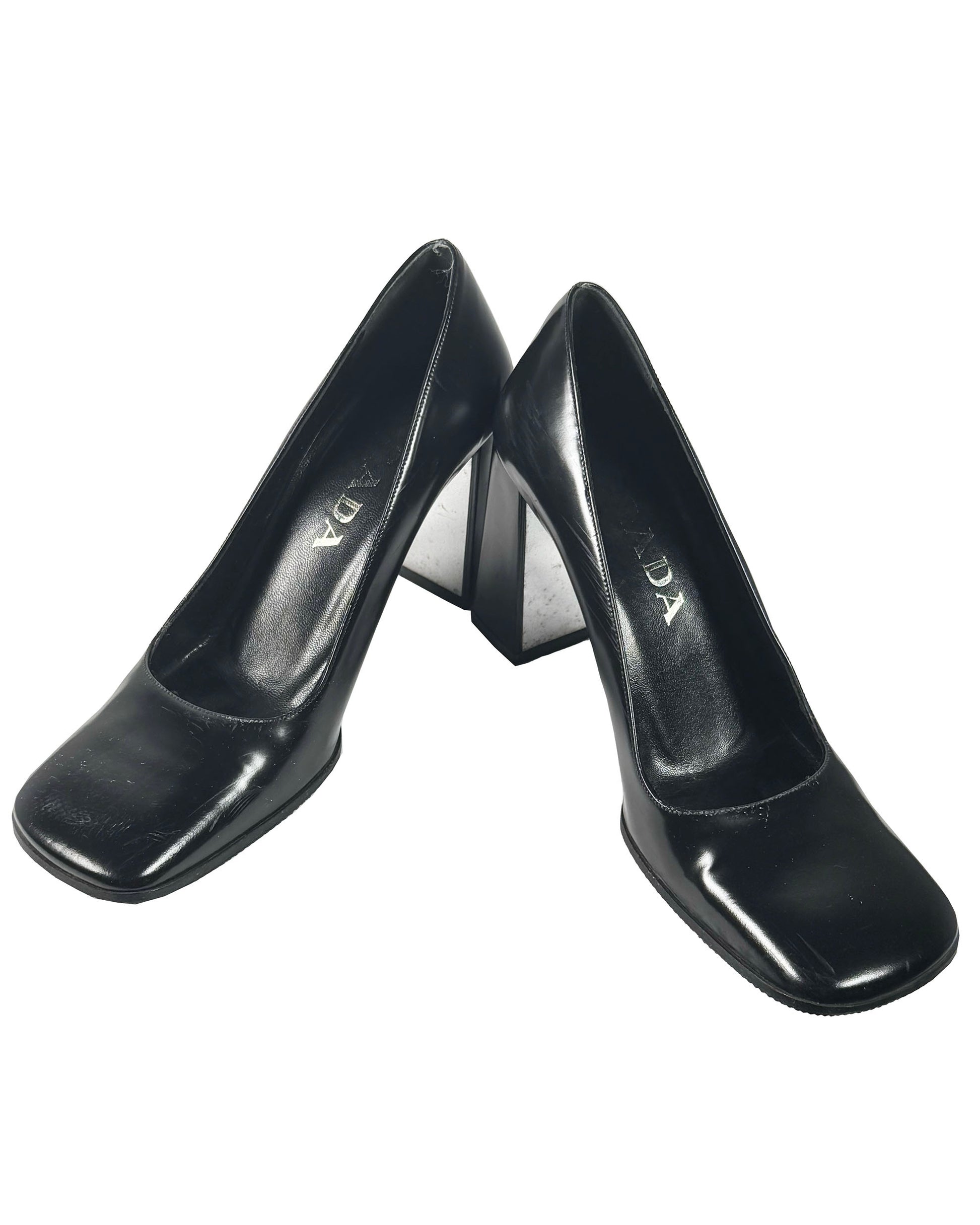 Pair of black high-heeled shoes on a white background