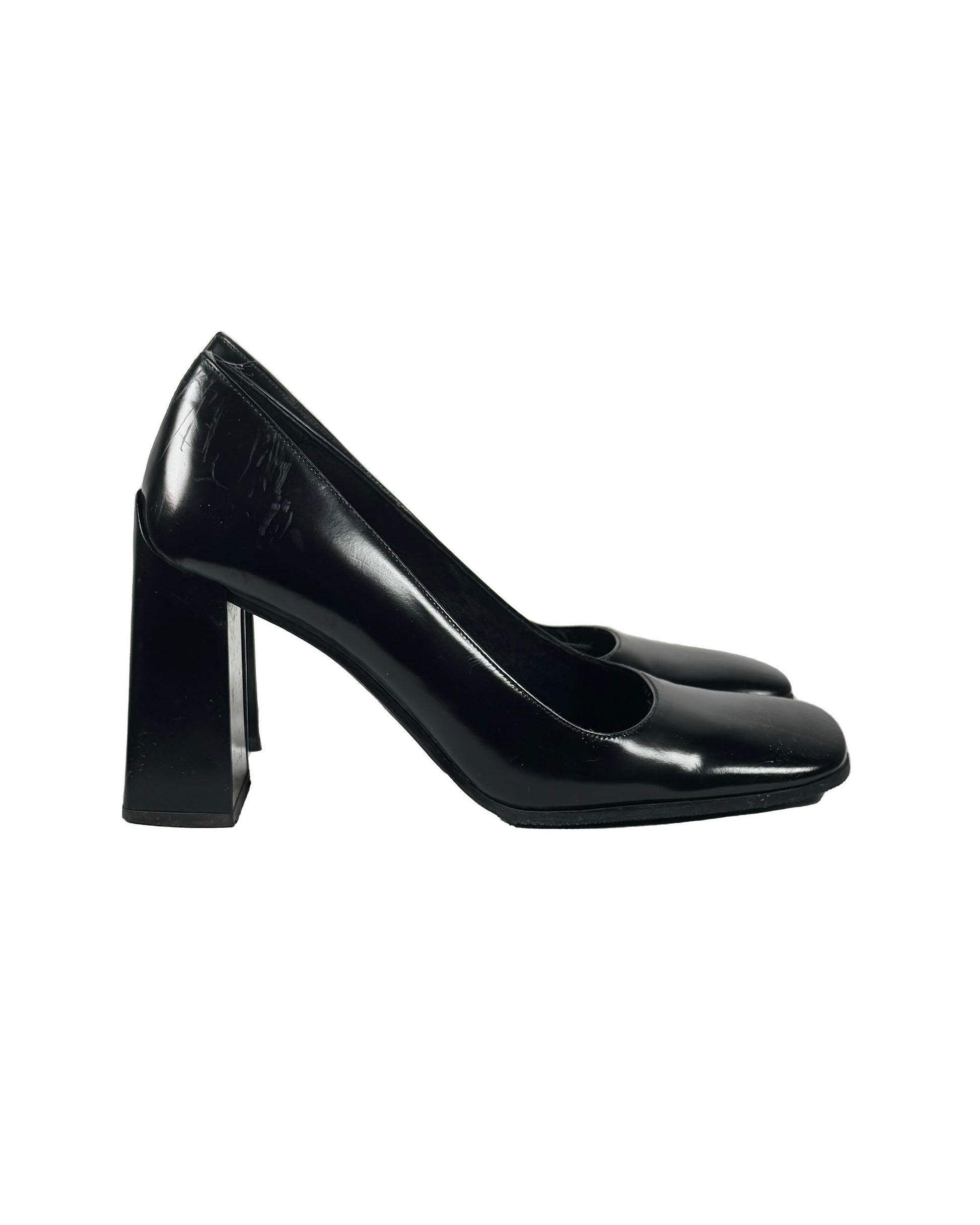 Black patent leather shoe on a white background