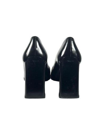 Pair of black high-heeled shoes on a white background