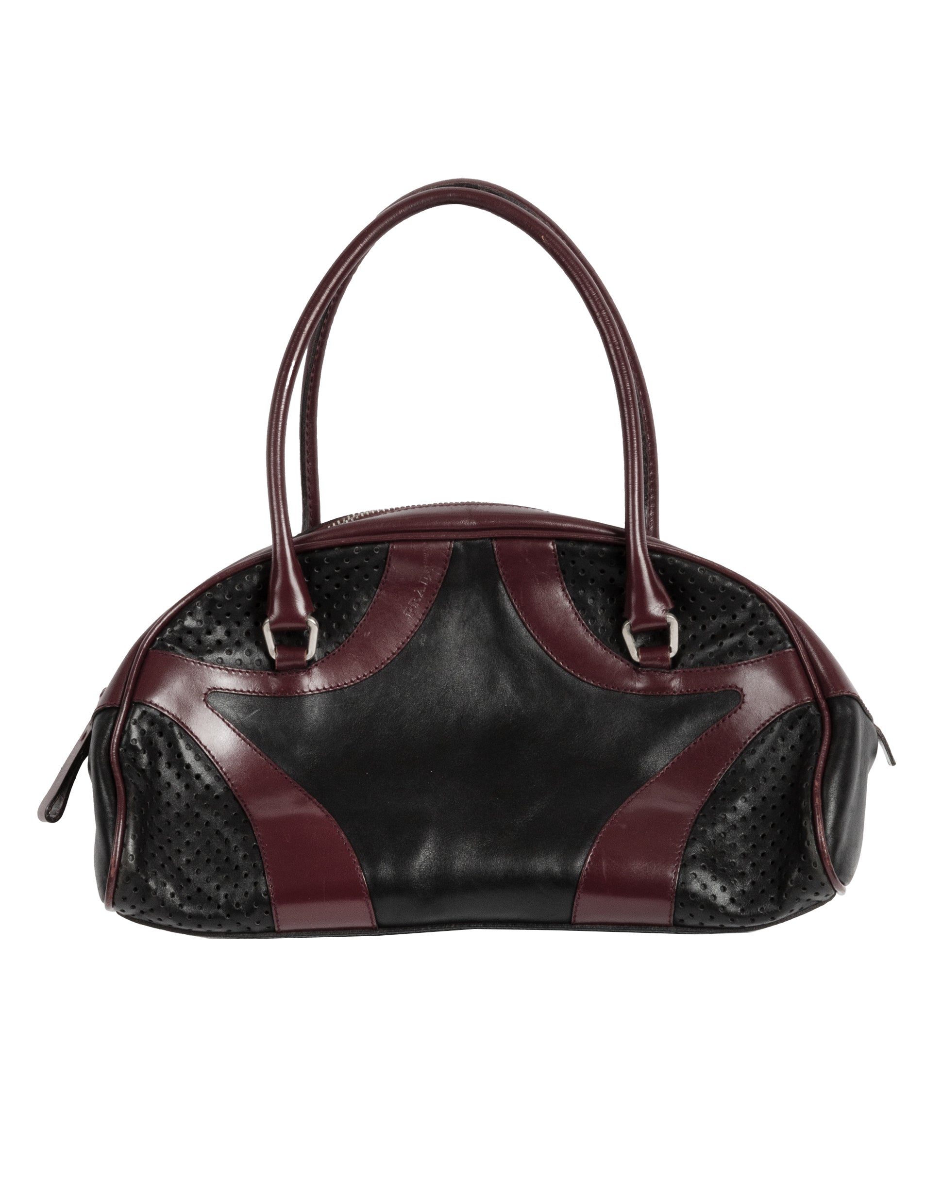 A black and burgundy leather bowling bag with perforated leather paneling and double handles.