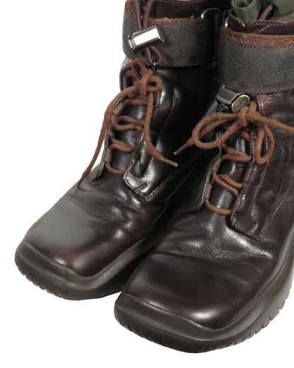Pair of brown leather boots with laces on a white background