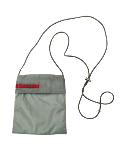 Gray pouch with a red label and black strap on a white background