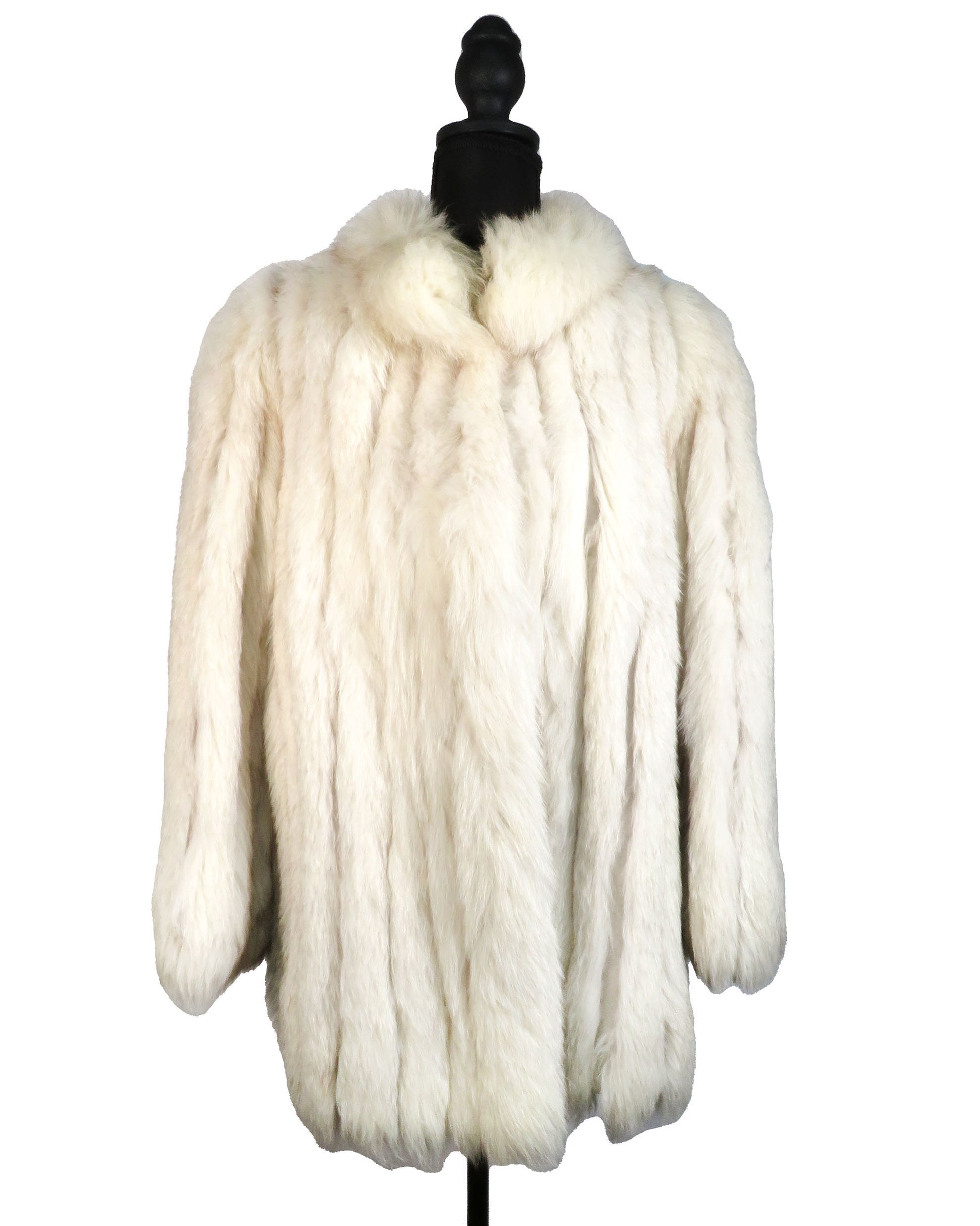 White fur coat on a mannequin against a white background