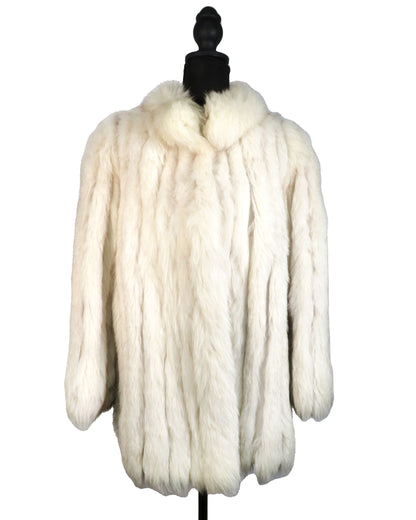 White fur coat on a mannequin against a white background