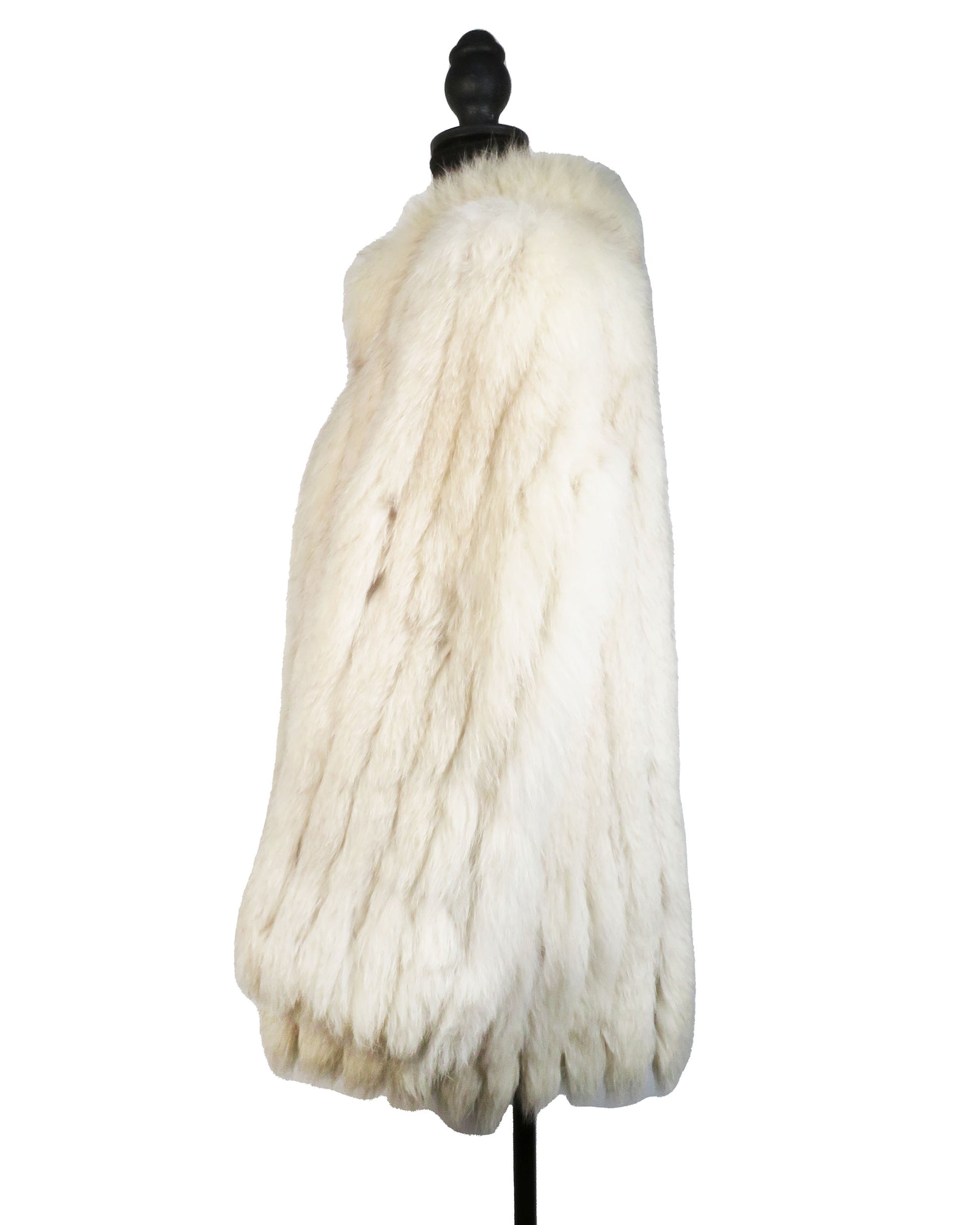 White fur coat on a mannequin against a white background