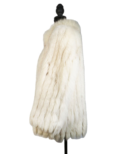 White fur coat on a mannequin against a white background