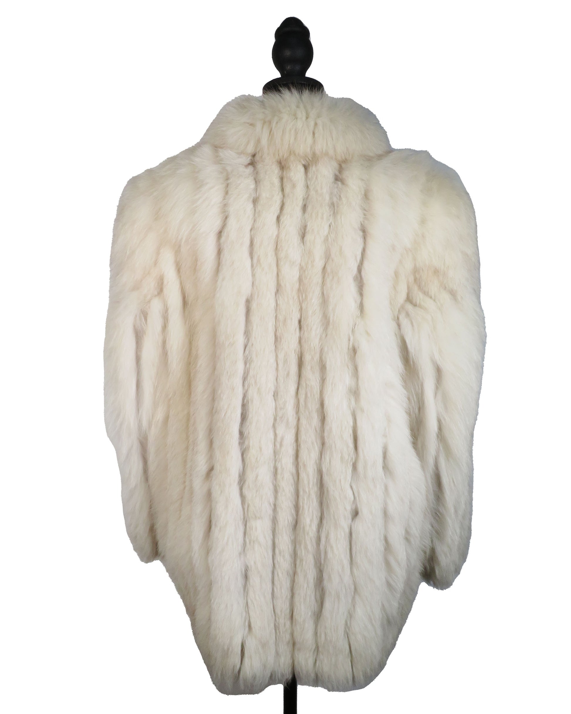 White fur coat on a mannequin against a white background