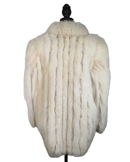 White fur coat on a mannequin against a white background