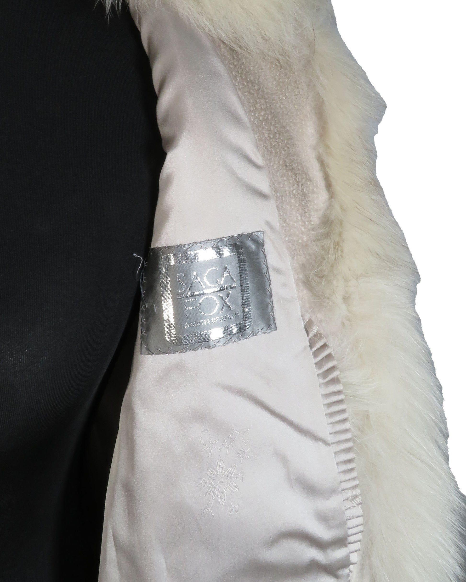 Close-up of a white garment with a visible label on a plain background