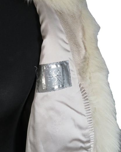 Close-up of a white garment with a visible label on a plain background