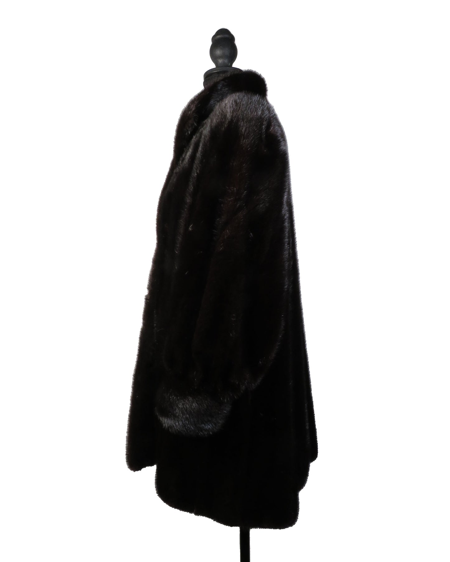 Black fur coat on a mannequin against a white background