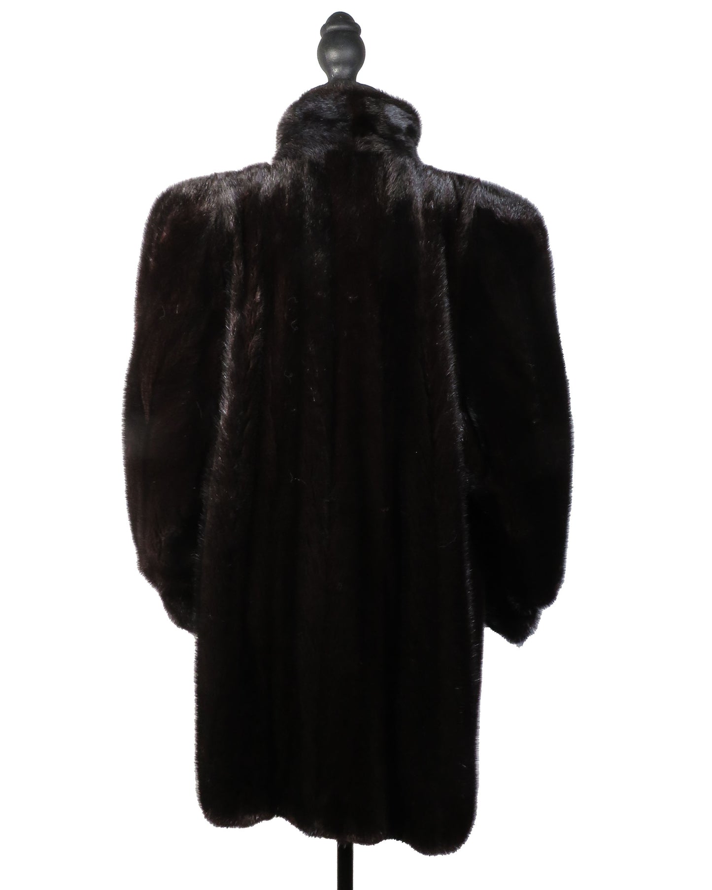 Dark fur coat on a mannequin against a white background