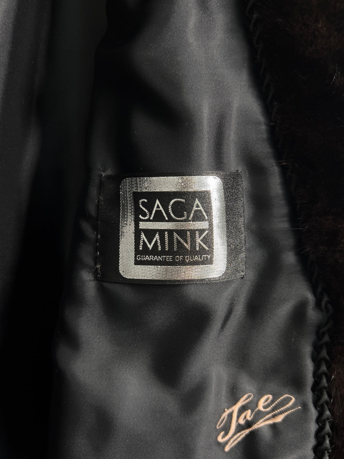 Close-up of a Saga Mink label on a fur product with 'Lae' branding.