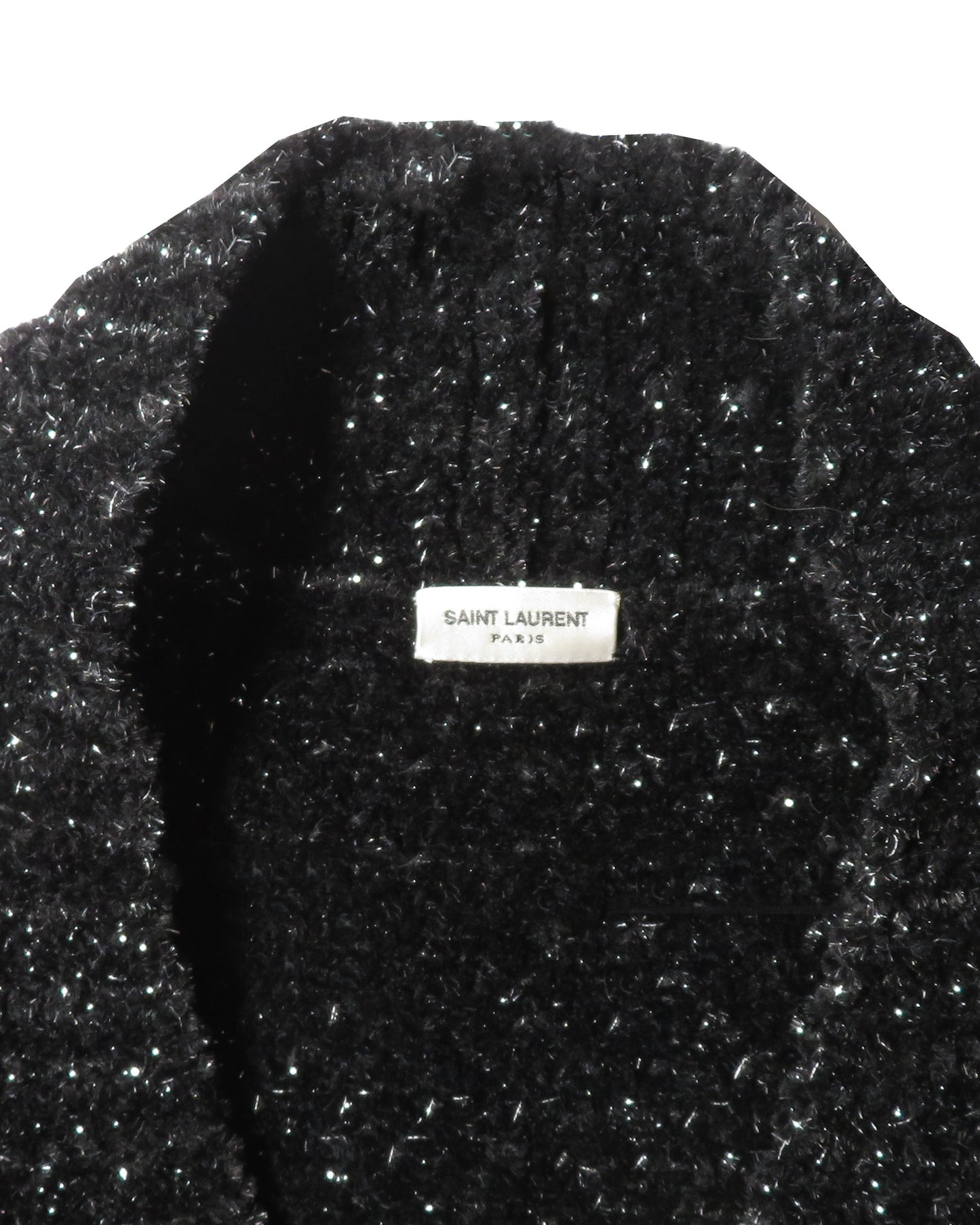 Black textured garment with Saint Laurent Paris label on a white background