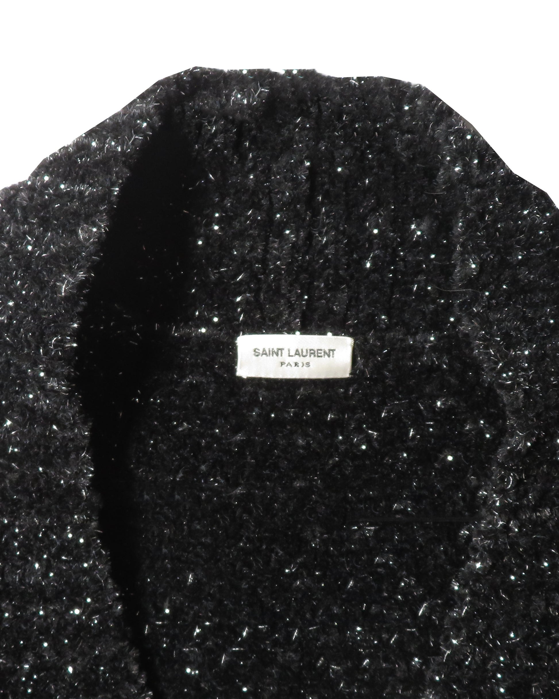Black textured garment with Saint Laurent Paris label on a white background