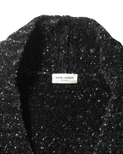 Black textured garment with Saint Laurent Paris label on a white background