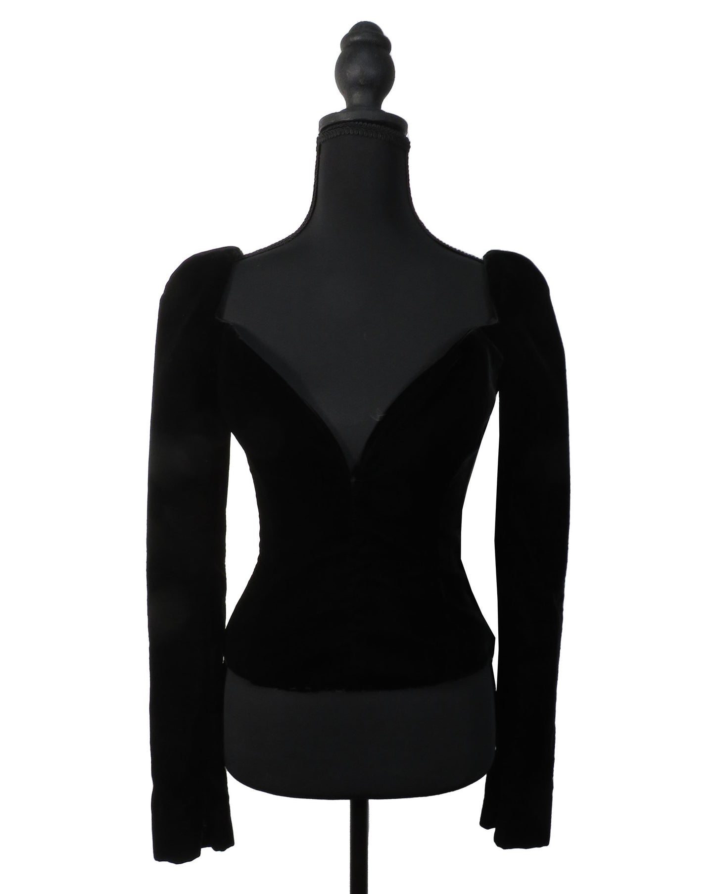 Black long-sleeve top on a mannequin against a white background