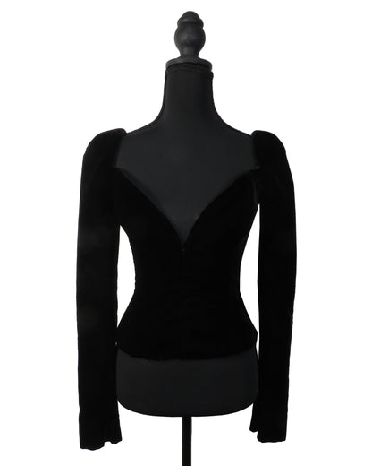 Black long-sleeve top on a mannequin against a white background