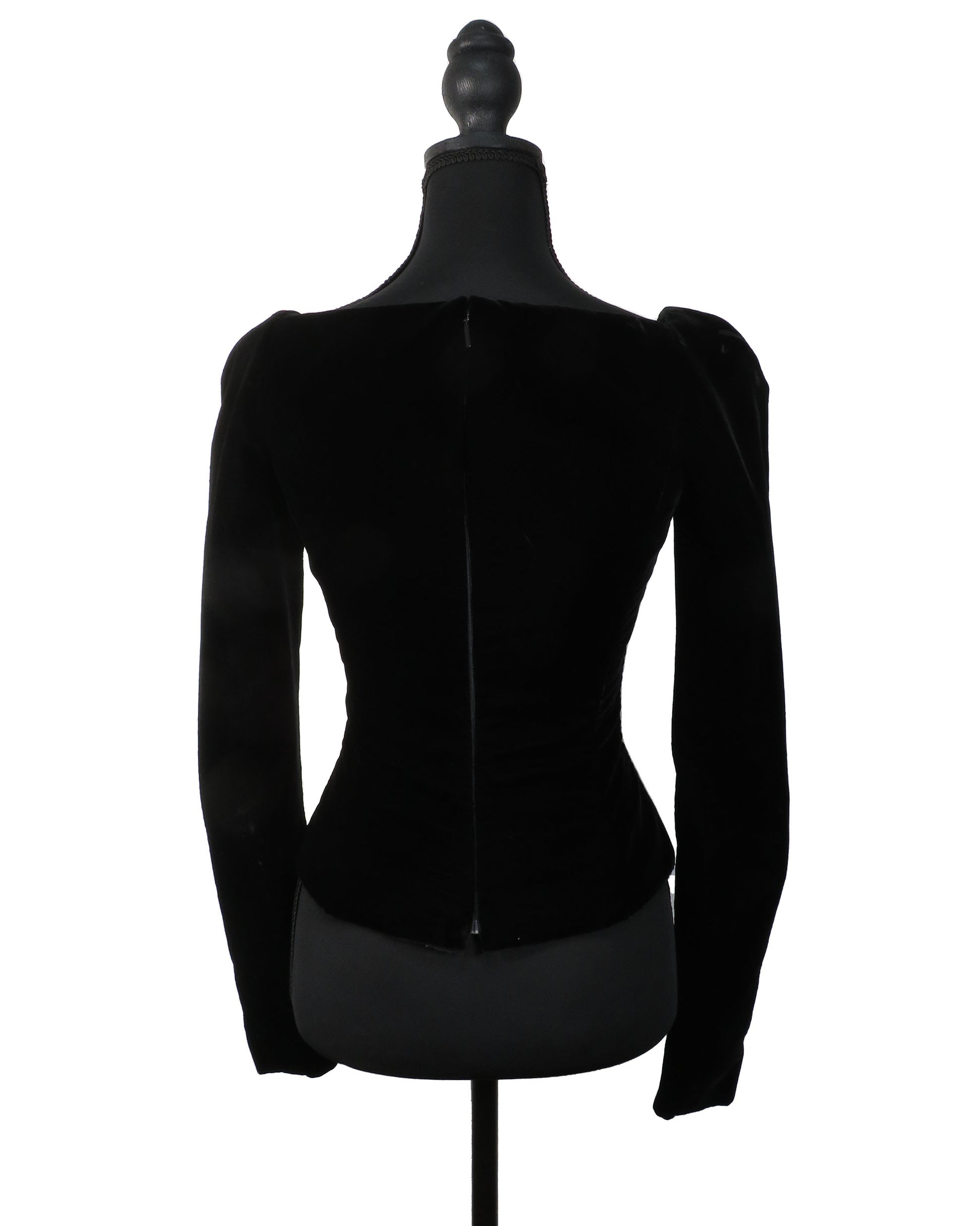 Black velvet jacket on a mannequin against a white background