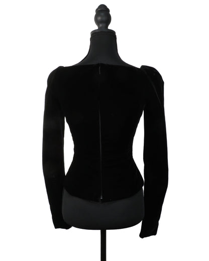 Black velvet jacket on a mannequin against a white background