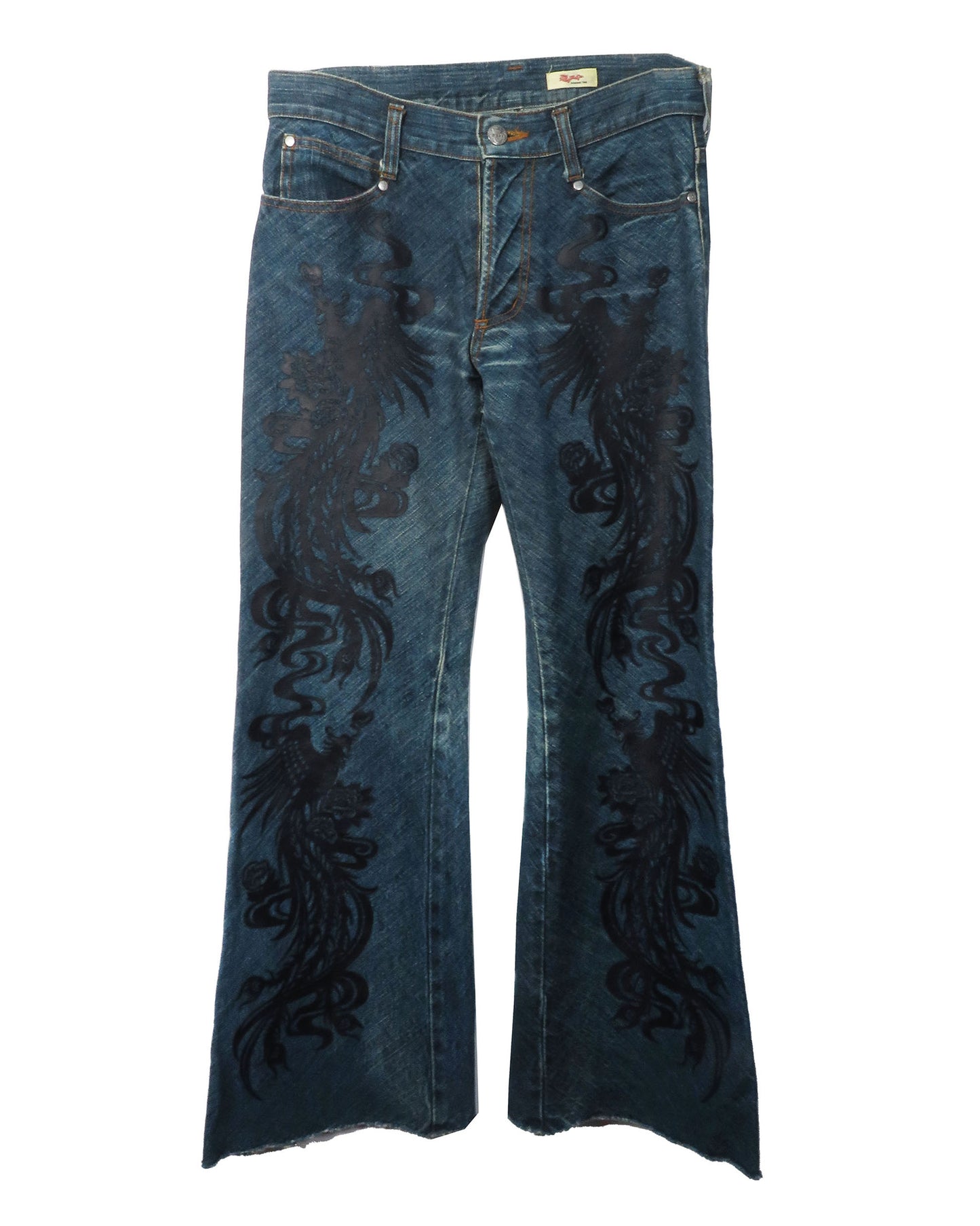 Blue jeans with black floral embroidery on a white background