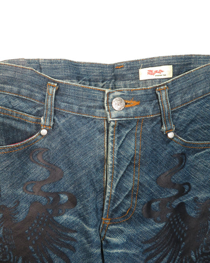 Close-up of blue jeans with a brand label on a white background