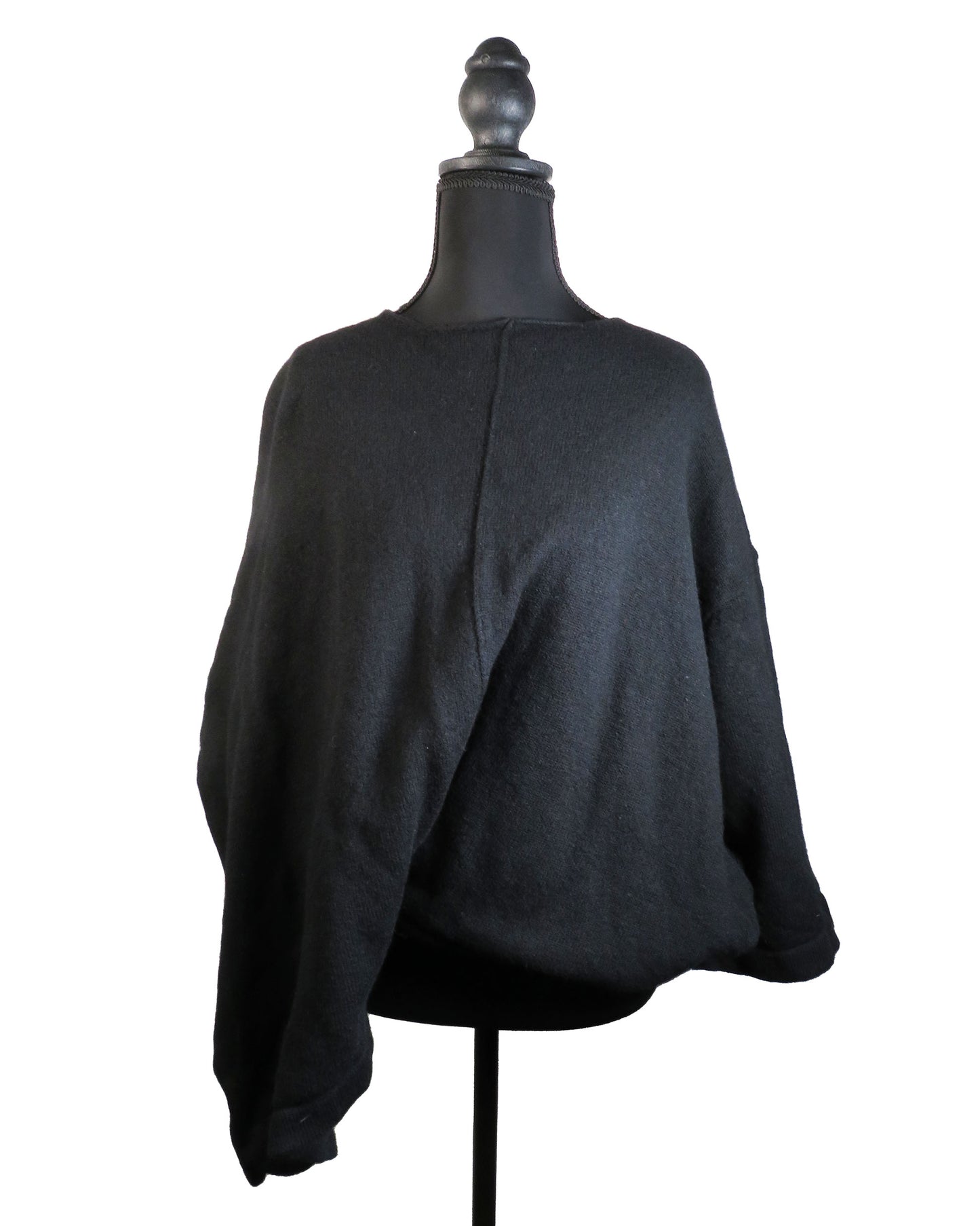 Black sweater on a mannequin against a white background