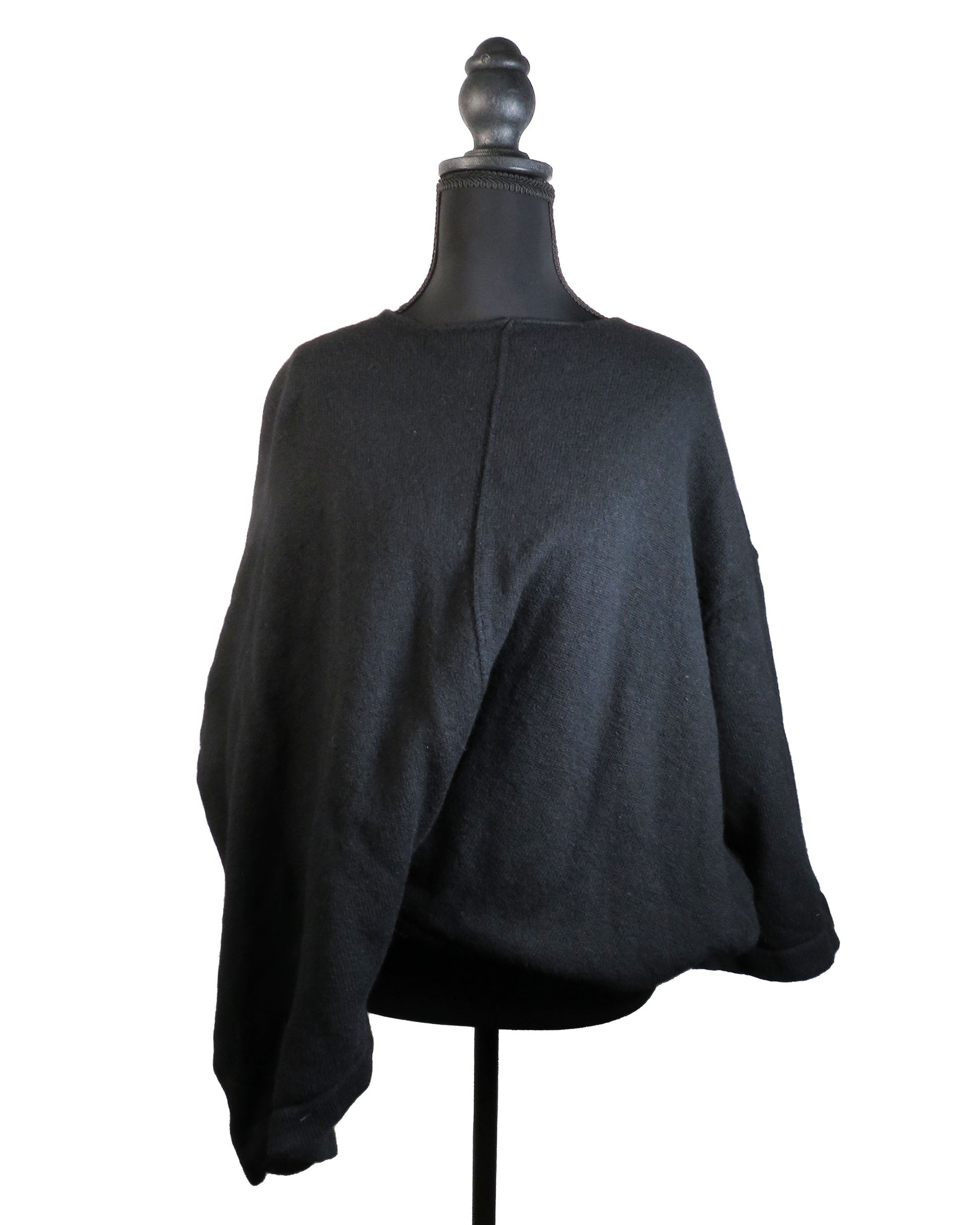 Black sweater on a mannequin against a white background