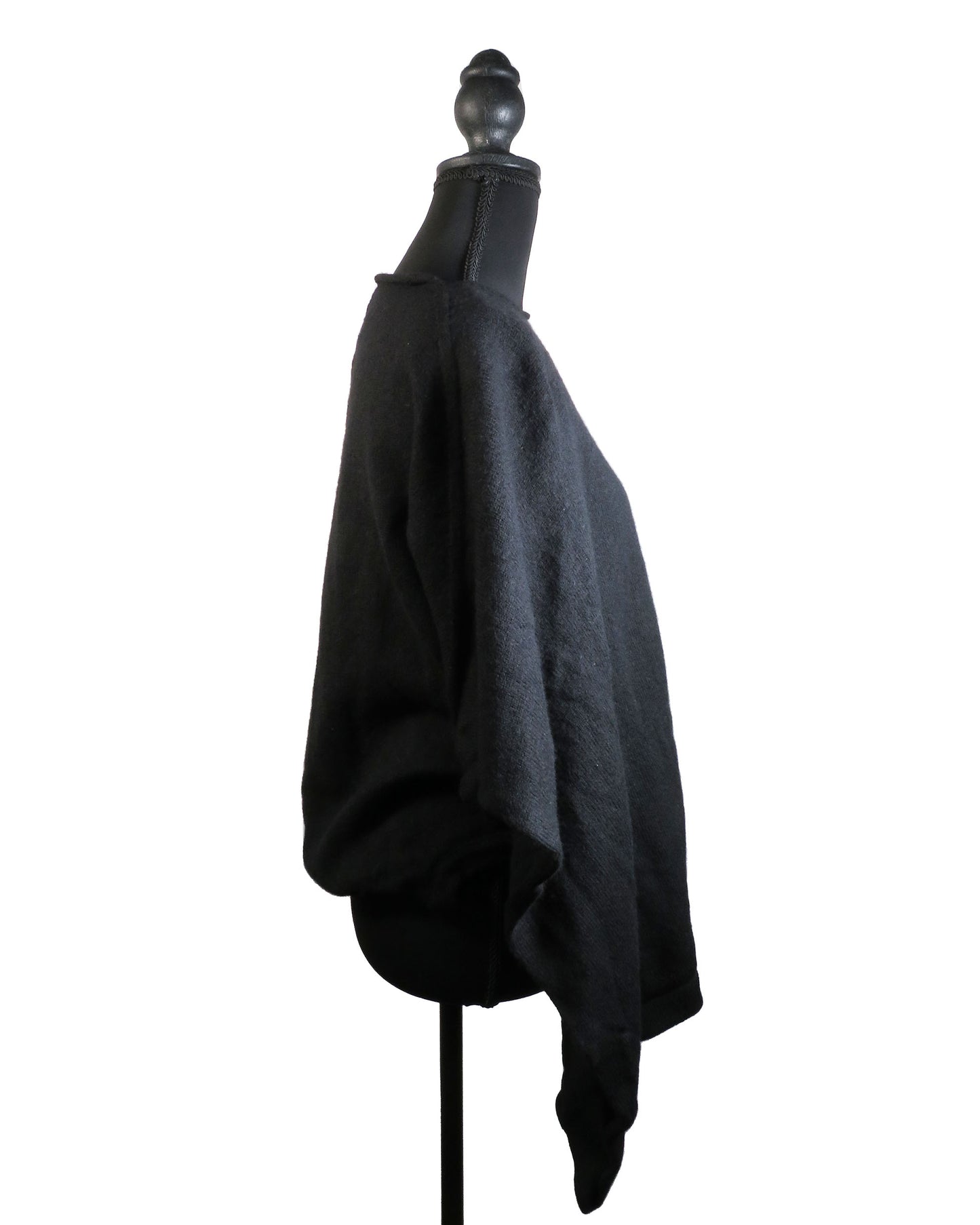 Black poncho on a mannequin against a white background