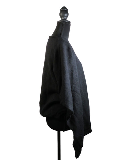 Black poncho on a mannequin against a white background