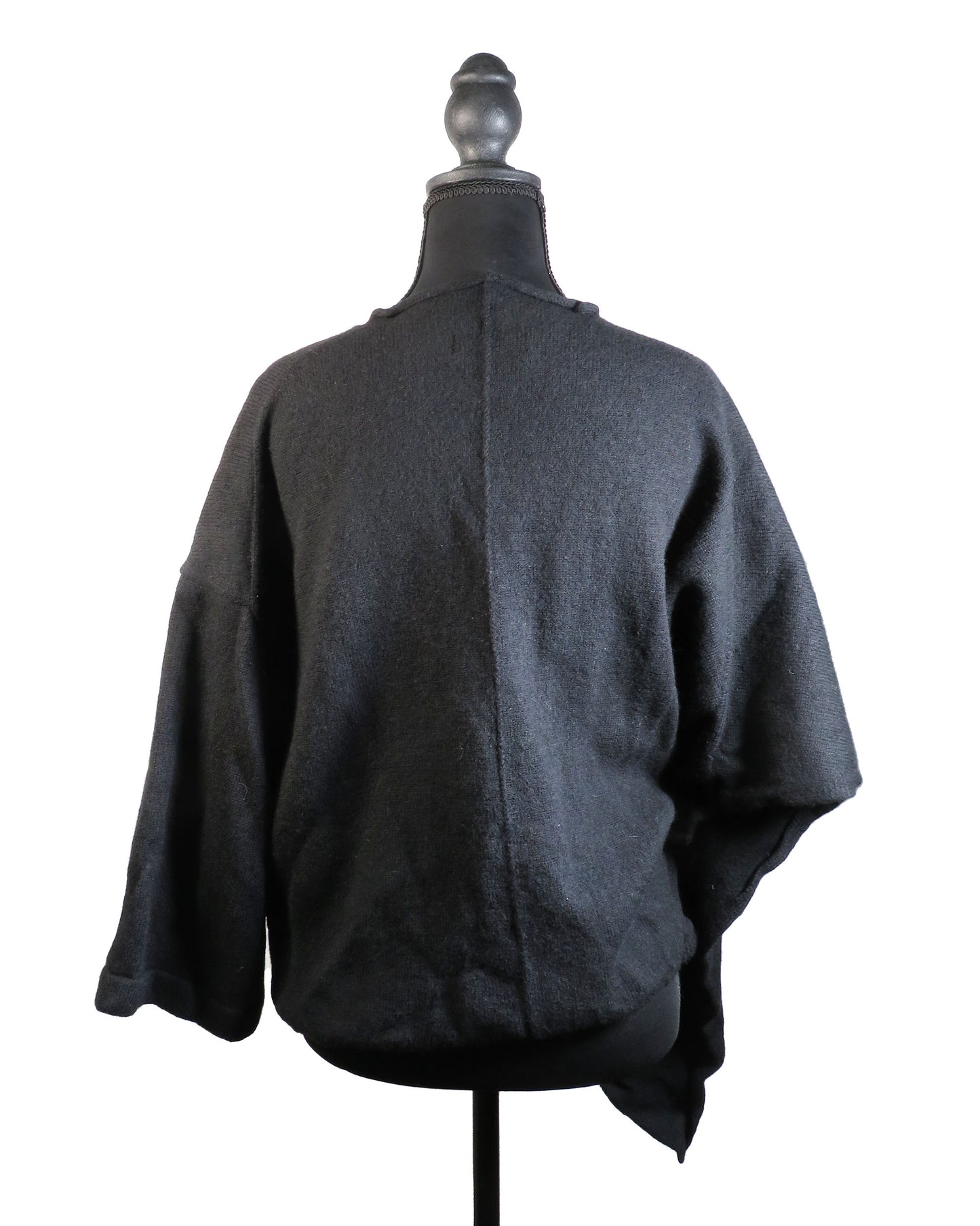 Dark gray poncho on a mannequin against a white background