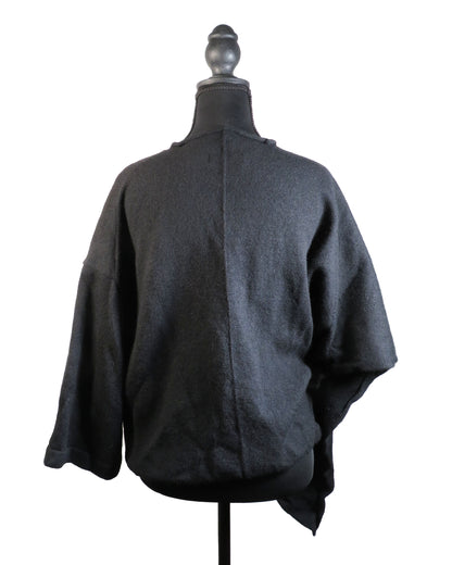 Dark gray poncho on a mannequin against a white background