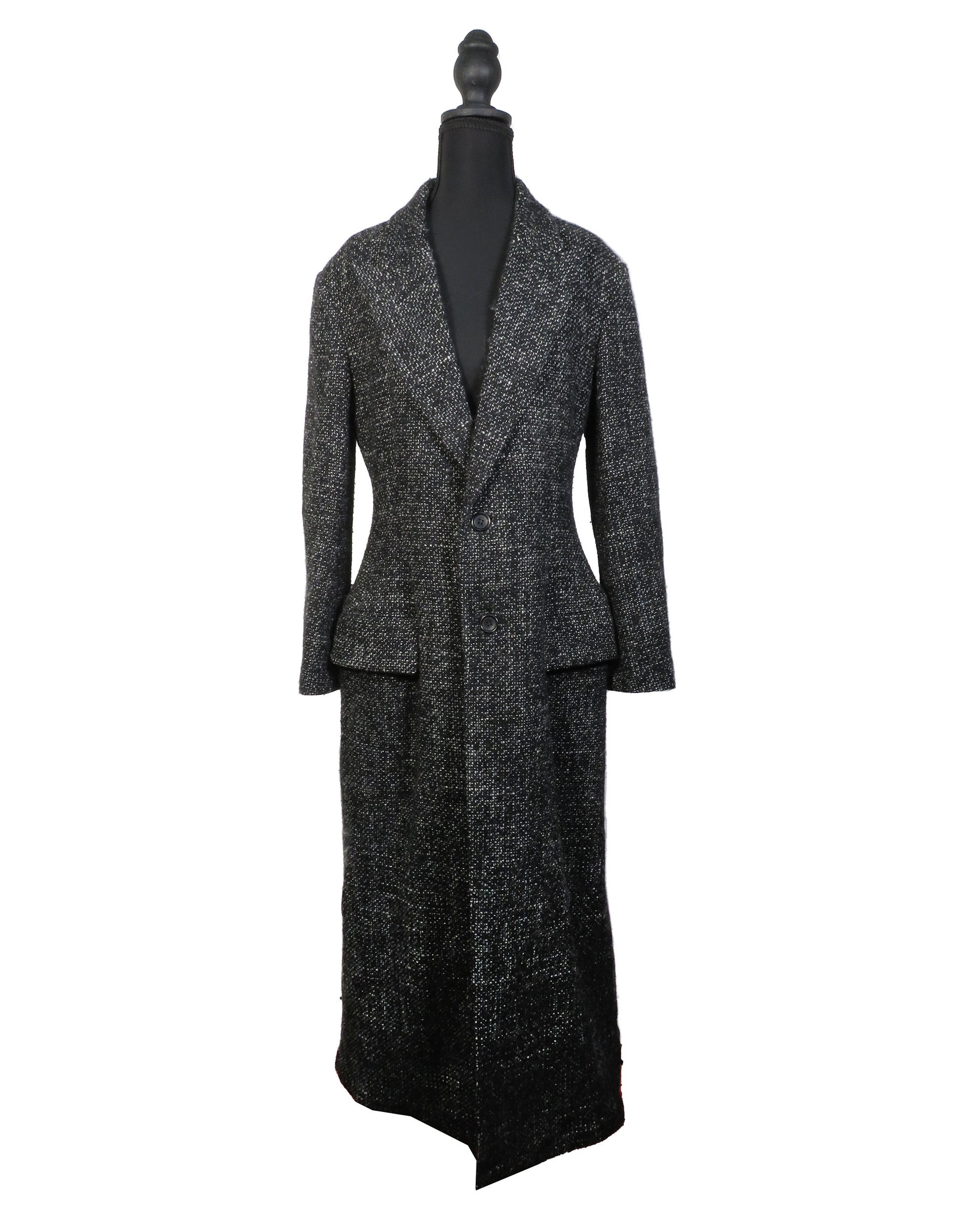 Black textured suit on a mannequin against a white background