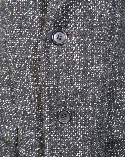 Close-up of a textured gray fabric with two buttons.