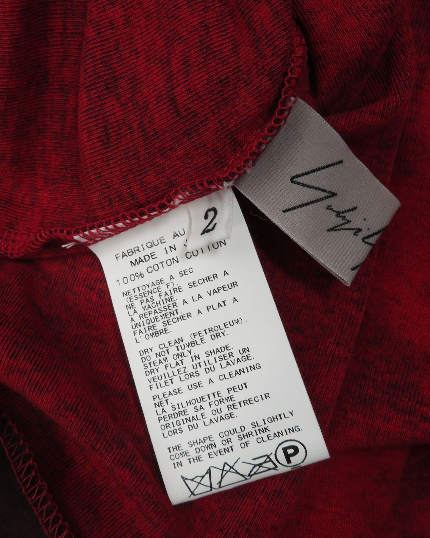 Red fabric with a label and 'Yigal' branding