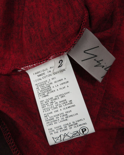 Red fabric with a label and 'Yigal' branding