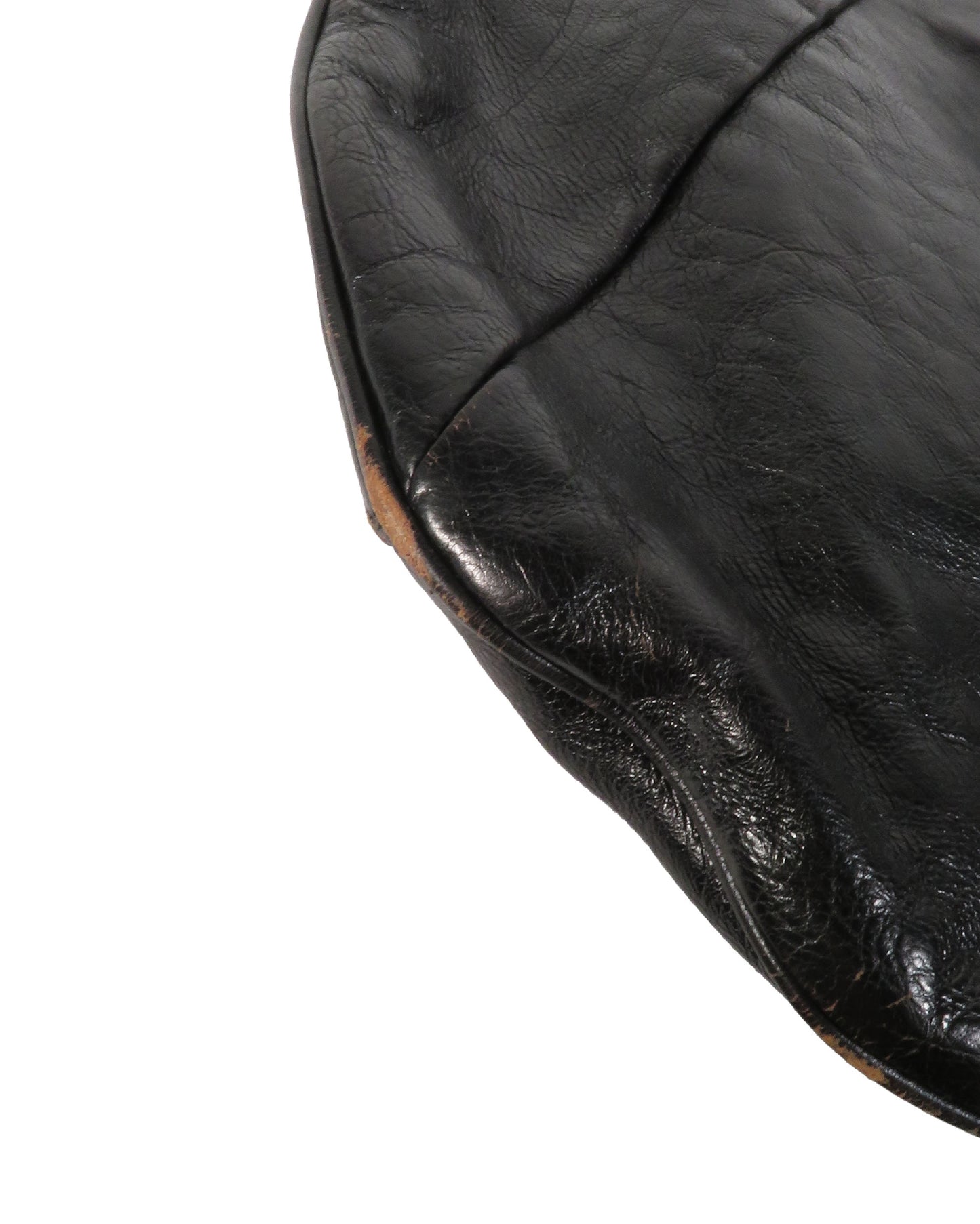 Close-up of a black leather chair seat on a white background