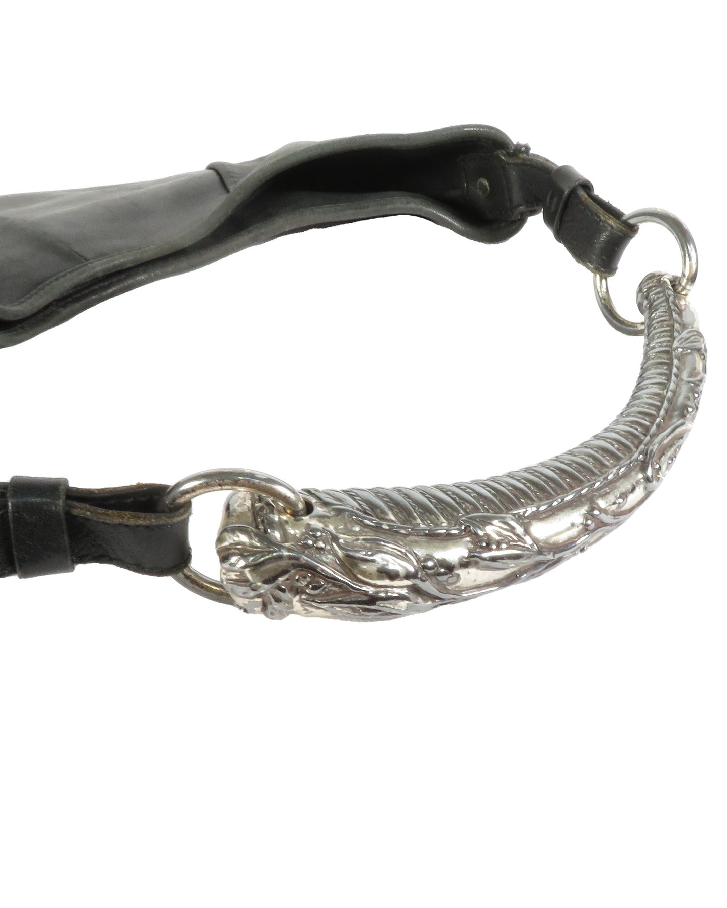 Close-up of a black leather strap with a silver decorative ring on a white background